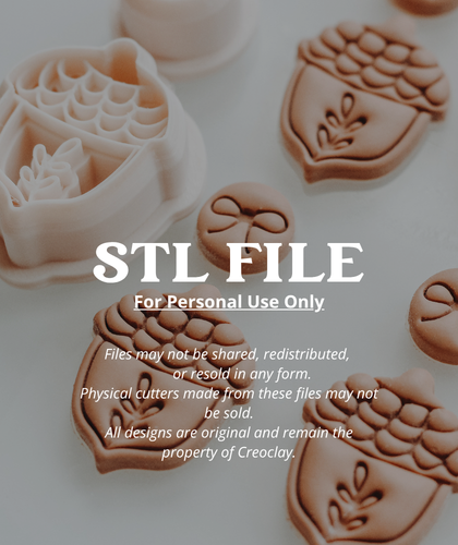Digital preview of a 3D printing STL file showing various acorn and bow clay cutters in pale pink and brown clay, with white text overlay reading &