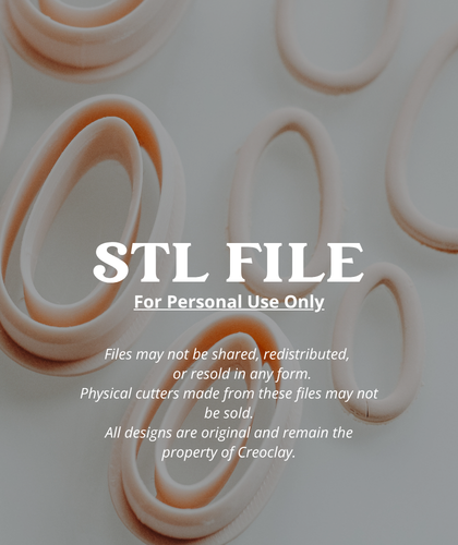 A set of peach-colored clay cutters and clay cutouts arranged on a clean, light gray background.