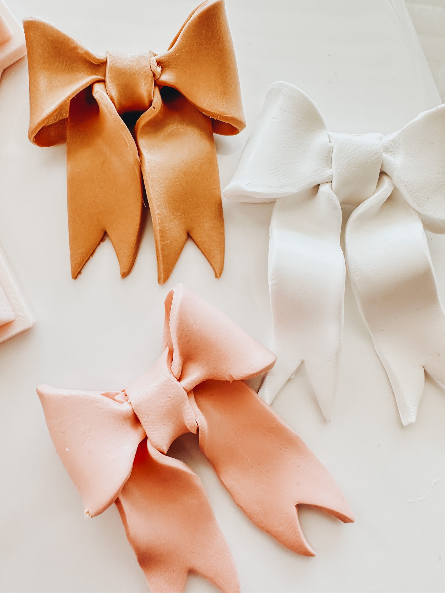 A close up image of a finished polymer clay bows.