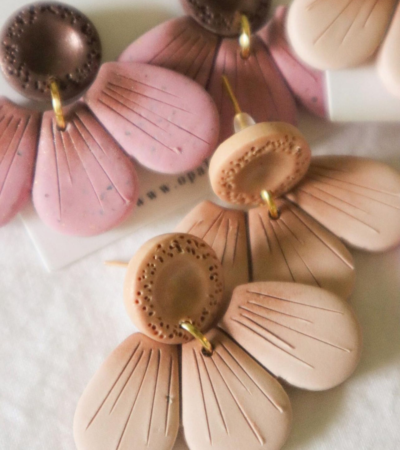 Example of a pair of polymer clay earrings finished by an artist.